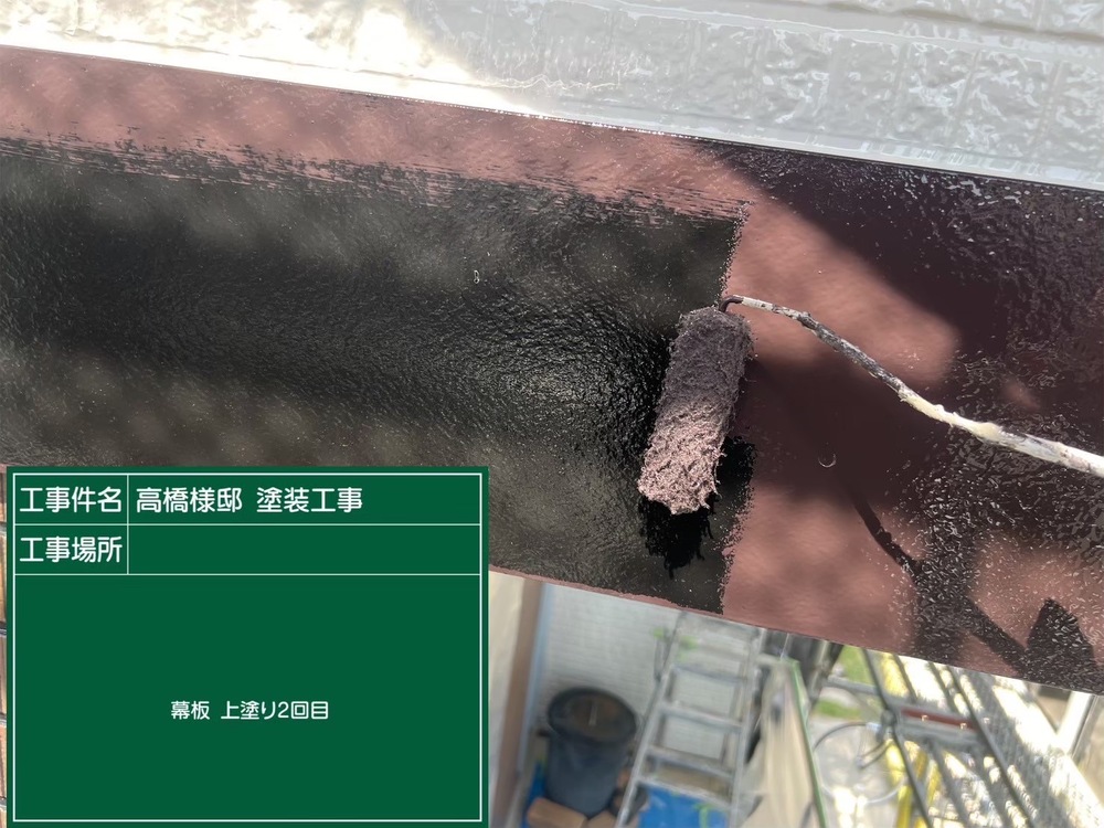 ローラーで外壁を厚膜に塗り重ねる作業