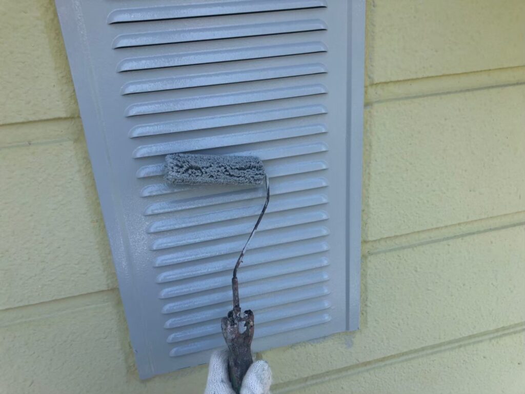 雨戸の表面を塗装している作業